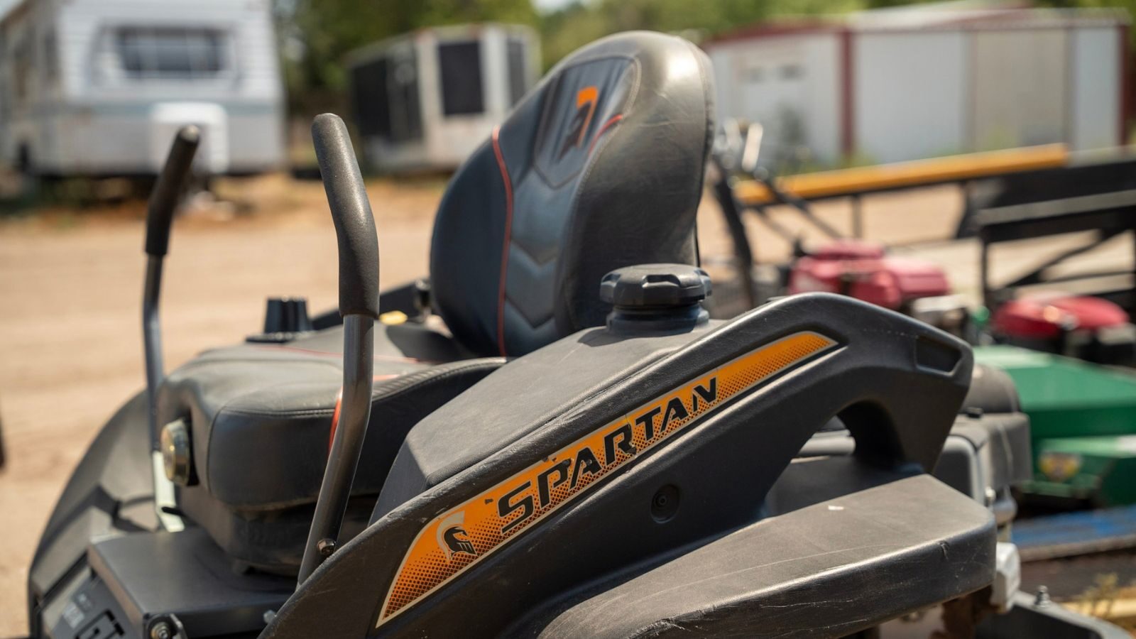 A riding lawn mower with its seat and controls.